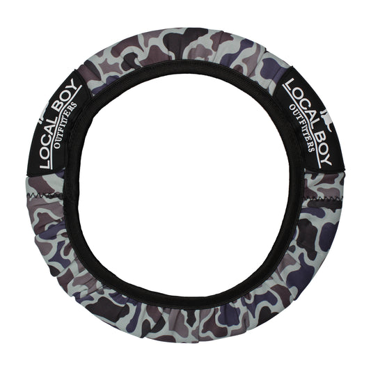 A camouflage-patterned steering wheel cover with the brand name 'Local Boy Outfitters' displayed on it.