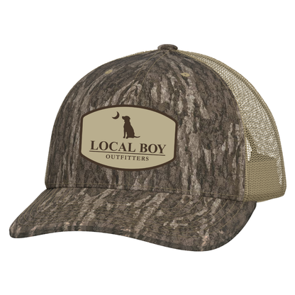 Pocket Badge Trucker Hat - Mossy Oak Bottomland